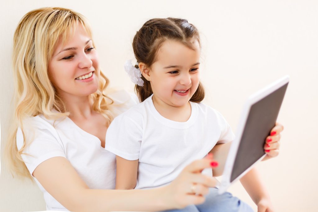 child and mother on tablet