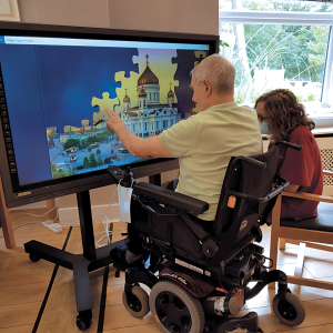 elderly interacting with G-Touch Interactive Display