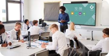 Teacher teaching in classroom using Visualiser and G-Touch Interactive display.