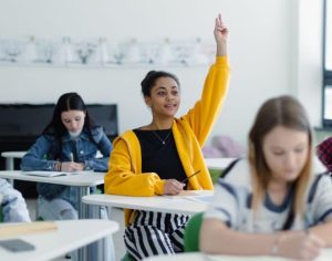 Student Raising Her hand in Class-rooom 